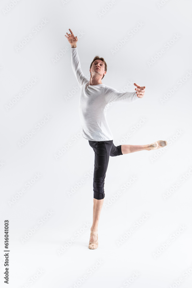Portrait of Training Caucasian Young, Handsome Sporty Athletic Ballet Dancer with Lifted Hand Over White.