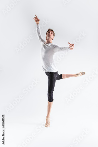 Portrait of Training Caucasian Young, Handsome Sporty Athletic Ballet Dancer with Lifted Hand Over White.