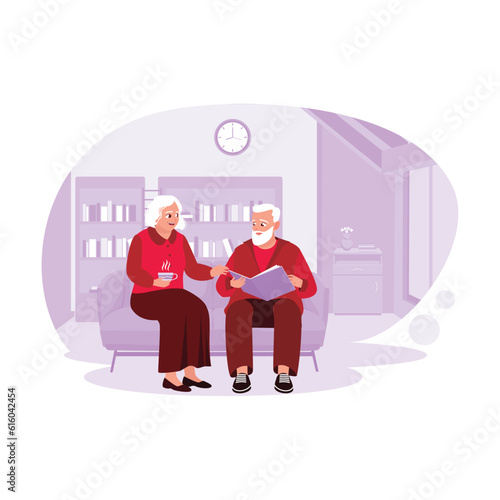 Elderly couple sitting together on the living room sofa, enjoying a relaxing time looking at album photos. Trend Modern vector flat illustration.
