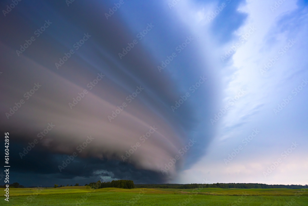 Angry supercell storm influenced by Climate change. Dangerous storm supercell shelf cloud with layers. Angry supercell storm influenced by Climate change. Dangerous storm supercell shelf cloud with layers.