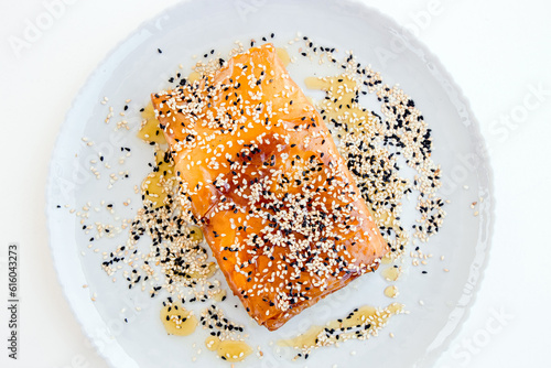 Fototapeta Naklejka Na Ścianę i Meble -  Feta cheese wrapped in crispy phyllo with sweet honey sauce and sesame seeds. Local Greek meze appetizer cuisine. Originally from Crete in Greece. Flat lay view.
