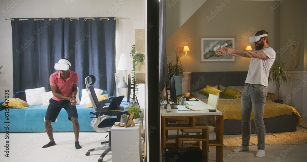 Multiracial men, neighbours in VR headsets play augmented reality video games using wireless controllers. View of two rooms or apartments separated by wall. Concept of neighbourhood and lifestyle. Multiracial men, neighbours in VR headsets play augmented reality video games using wireless controllers. View of two rooms or apartments separated by wall. Concept of neighbourhood and lifestyle.