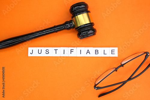 Obraz na plátně judge's gavel and glasses with the word justifiable