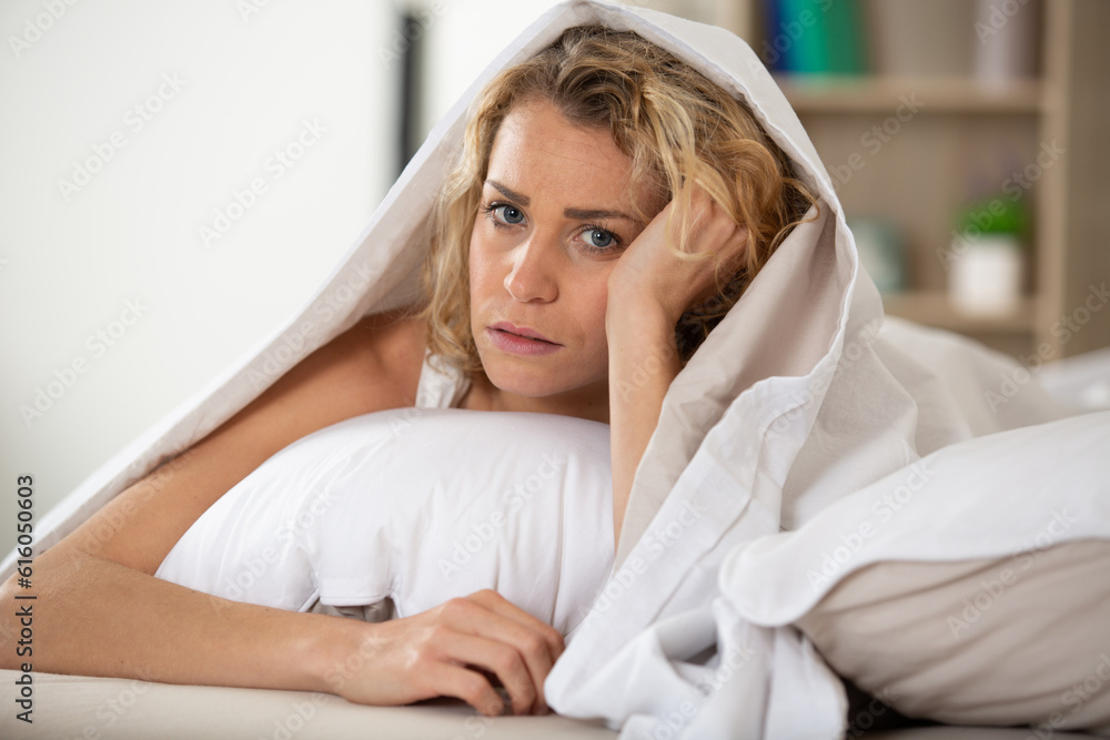 attractive thoughtful curl woman with a pillow on the bed attractive thoughtful curl woman with a pillow on the bed