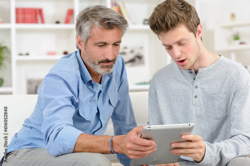 Two men looking at tablet Two men looking at tablet