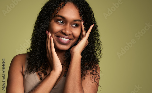 Cheerful black woman touching cheeks
