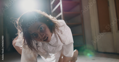 Tableau sur toile Scary female psychopath crawling in corridor of cursed house with unnatural moves