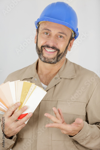 carpenter showing some baseboard swatches to a customer photo