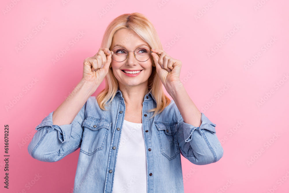 Photo of senior funny lady presenting computer glasses optician consultation reading side news isolated pink color background Photo of senior funny lady presenting computer glasses optician consultation reading side news isolated pink color background
