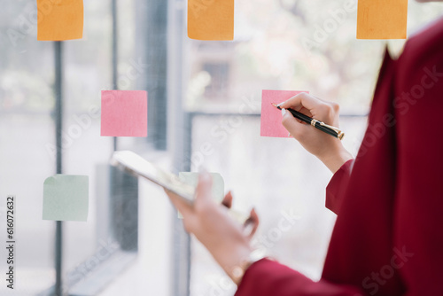 businesswoman using a smartphone in a creative office.