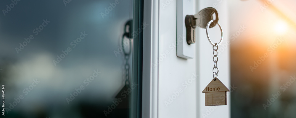 Landlord key for unlocking house is plugged into the door. Second hand house for rent and sale. keychain is blowing in the wind. mortgage for new home, buy, sell, renovate, investment, owner, estate Landlord key for unlocking house is plugged into the door. Second hand house for rent and sale. keychain is blowing in the wind. mortgage for new home, buy, sell, renovate, investment, owner, estate