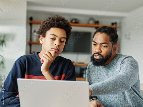 Canvas Print father child home family homework son  teenage parent education laptop teen boy