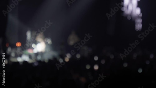 Blurred background with party people raving in the night club music party.