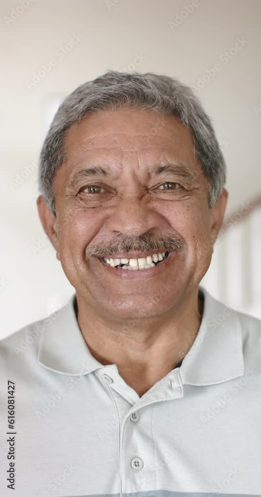 Vertical video of portrait of happy biracial senior man at home, slow motion Vertical video of portrait of happy biracial senior man at home, slow motion