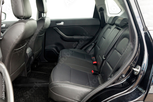 studio photo on a white background of the back row of seats the interior of a budget car SUV