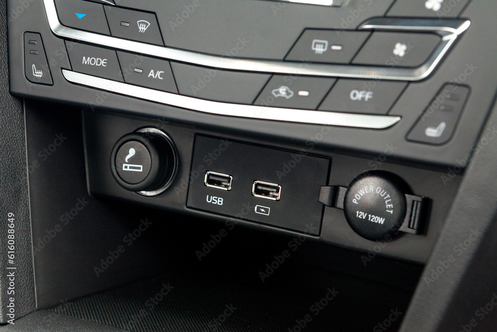 The central control console on the panel inside the budget car close-up with climate control and audio system
