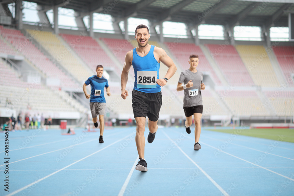 Men running a race at a stadium
