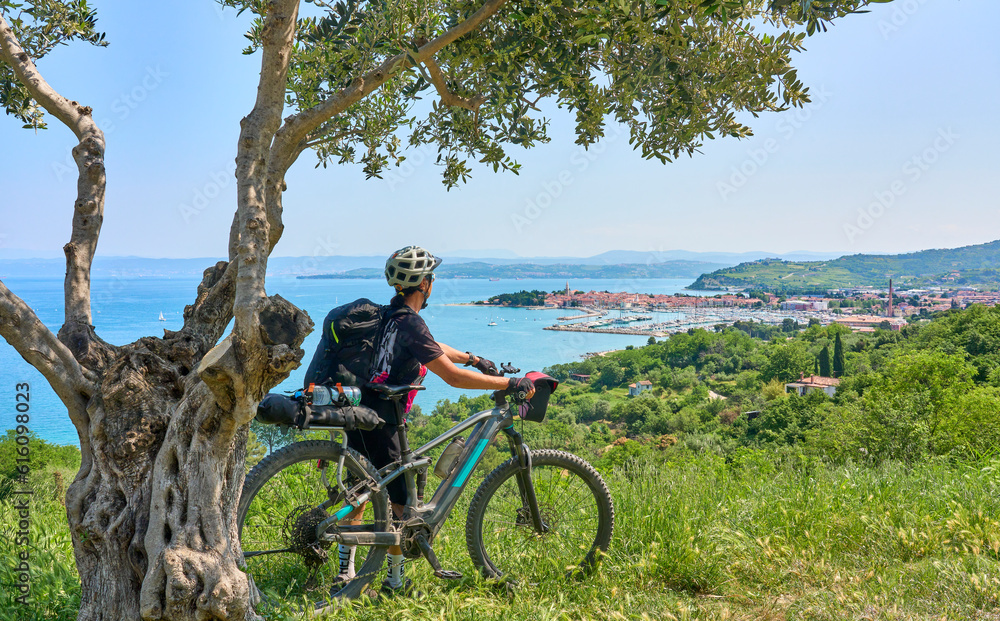 Obraz premium nice active senior woman on a mountain bike tour at the Slovenian Mediterranen cost above Izola