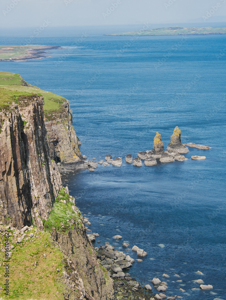 Kilt Rock - Cliffs with columnar structure on the northern coast of the Scottish Isle of Skye. Small rocky islands in the sea