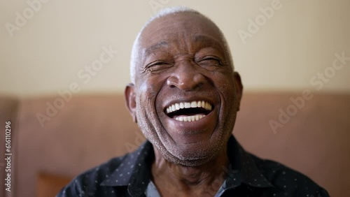 One joyful Senior Black Brazilian man smiling and laughing at camera. Friendly charismatic African American elderly person photo