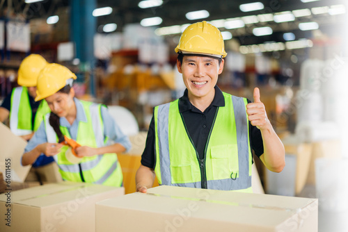Warehouse workers using a digital tablet while recording inventory. Logistics employees working with warehouse management software in a large distribution centre.