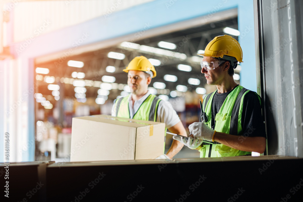 Three warehouse workers using a digital tablet while recording inventory. Logistics employees working with warehouse management software in a large distribution centre. Three warehouse workers using a digital tablet while recording inventory. Logistics employees working with warehouse management software in a large distribution centre.