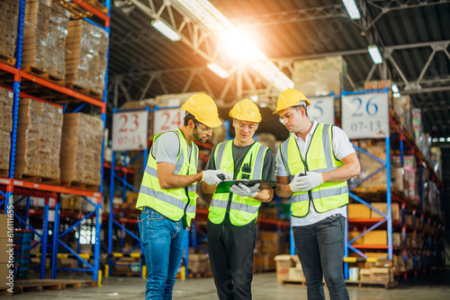 Three warehouse workers using a digital tablet while recording inventory Fototapet