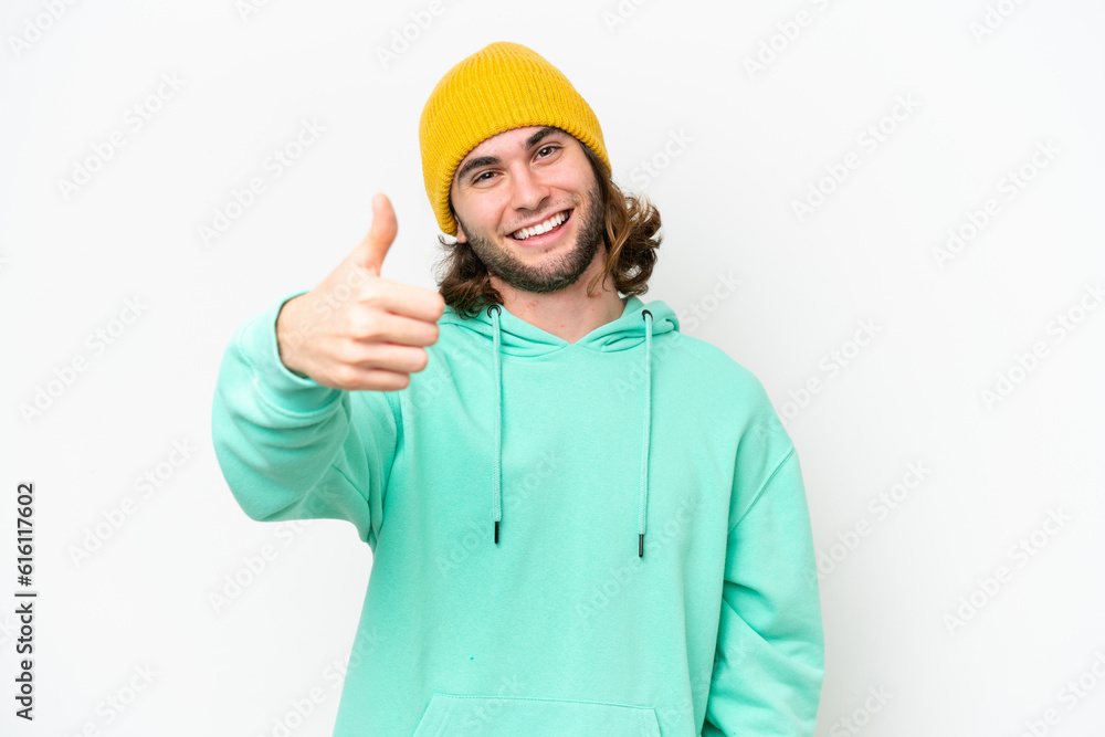 Young handsome man isolated on white chroma background with thumbs up because something good has happened