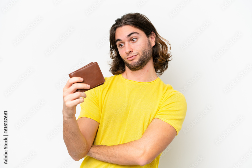 Young handsome man holding a wallet isolated on white background with sad expression Young handsome man holding a wallet isolated on white background with sad expression