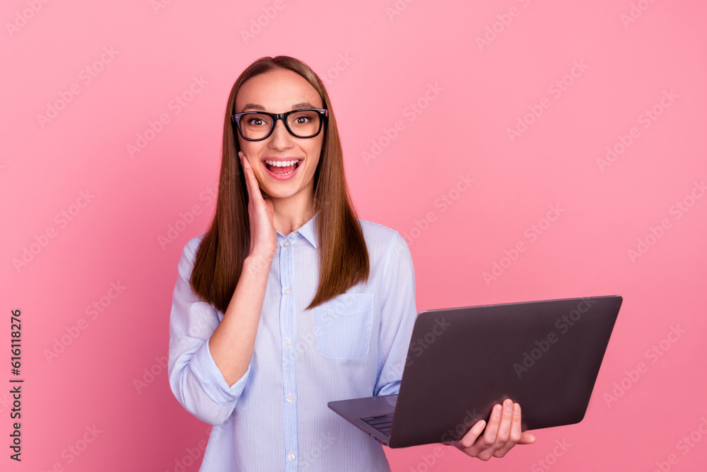 Photo of shocked girl working on laptop read good news isolated pink color background Photo of shocked girl working on laptop read good news isolated pink color background