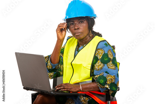 close up of female engineer in protective helmet working using laptop computer.