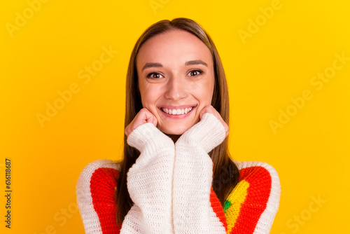 Photo of adorable positive lady look hands cheeks wear white shirt isolated yellow color background