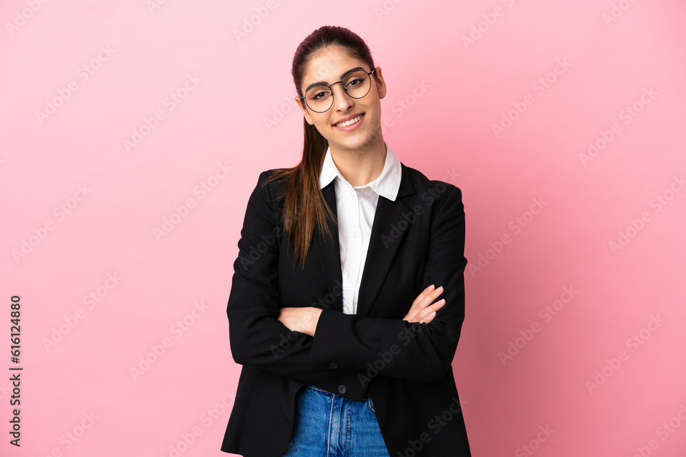 Young caucasian business woman isolated on pink background keeping the arms crossed in frontal position