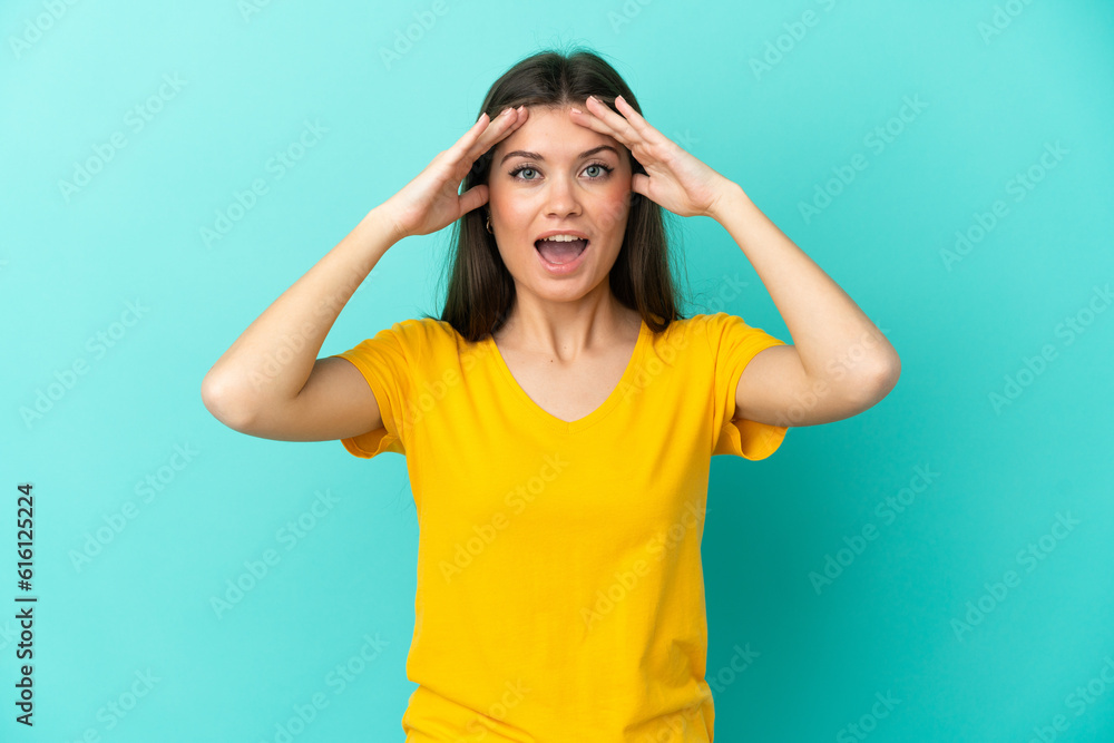 Young caucasian woman isolated on blue background with surprise expression Young caucasian woman isolated on blue background with surprise expression