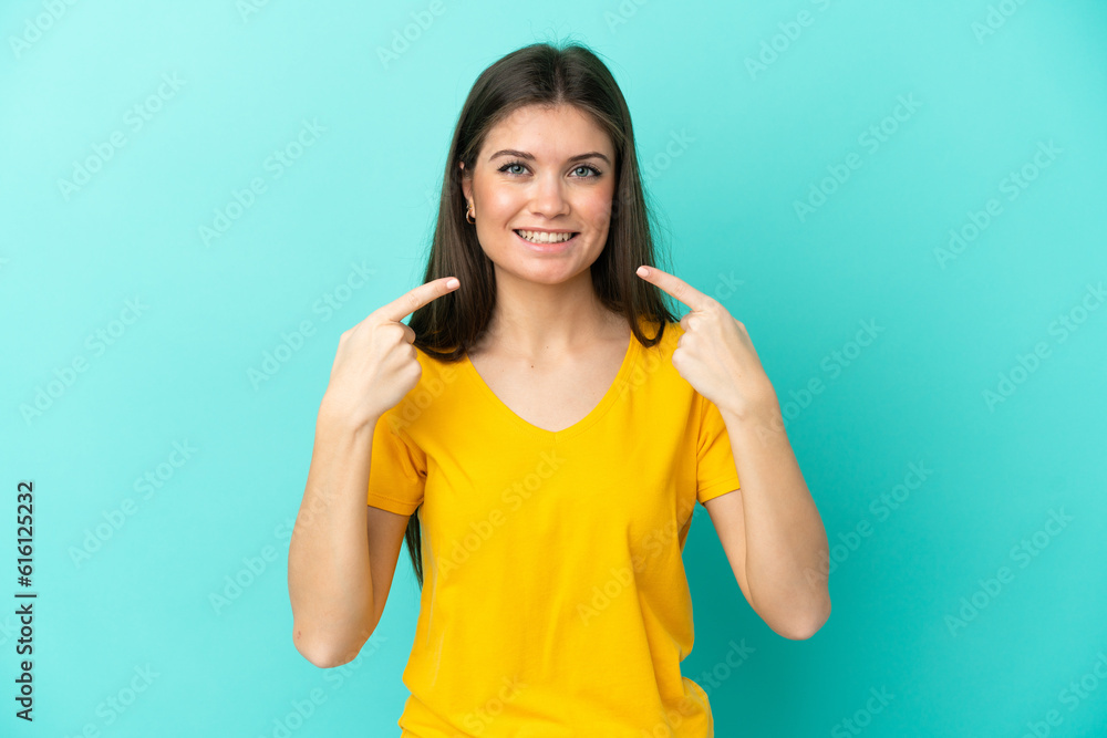 Young caucasian woman isolated on blue background giving a thumbs up gesture Young caucasian woman isolated on blue background giving a thumbs up gesture