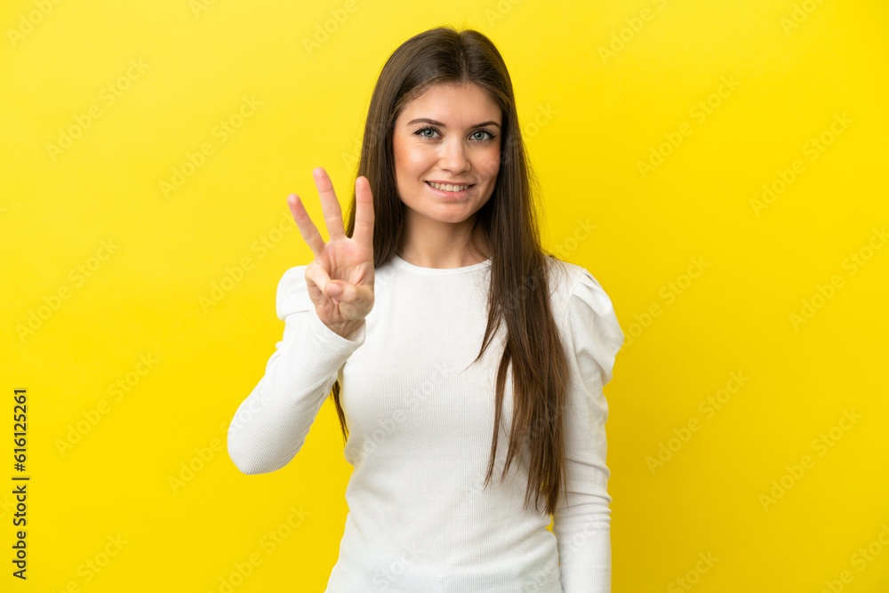 Young caucasian woman isolated on yellow background happy and counting three with fingers Young caucasian woman isolated on yellow background happy and counting three with fingers