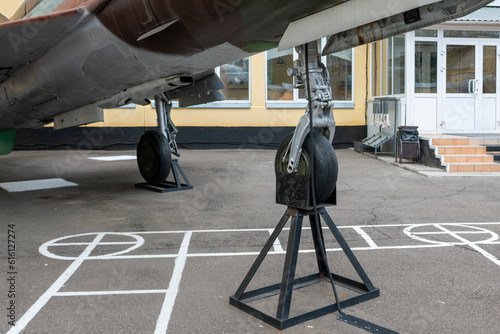 Aircraft landing gear in military coloring at a military base in the city. photo