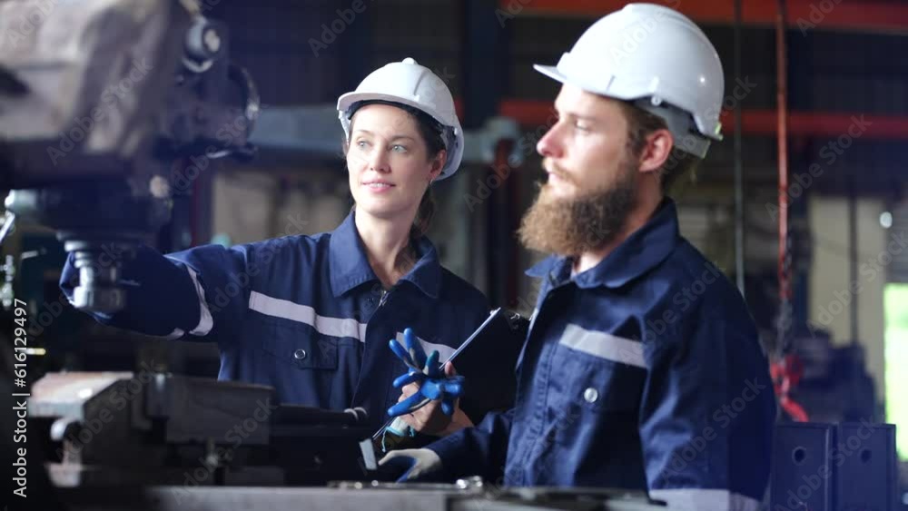 industrial Engineer manager man demonstration and training mechanic worker woman operating industrial lathe machine and checking quality control industrial Engineer manager man demonstration and training mechanic worker woman operating industrial lathe machine and checking quality control