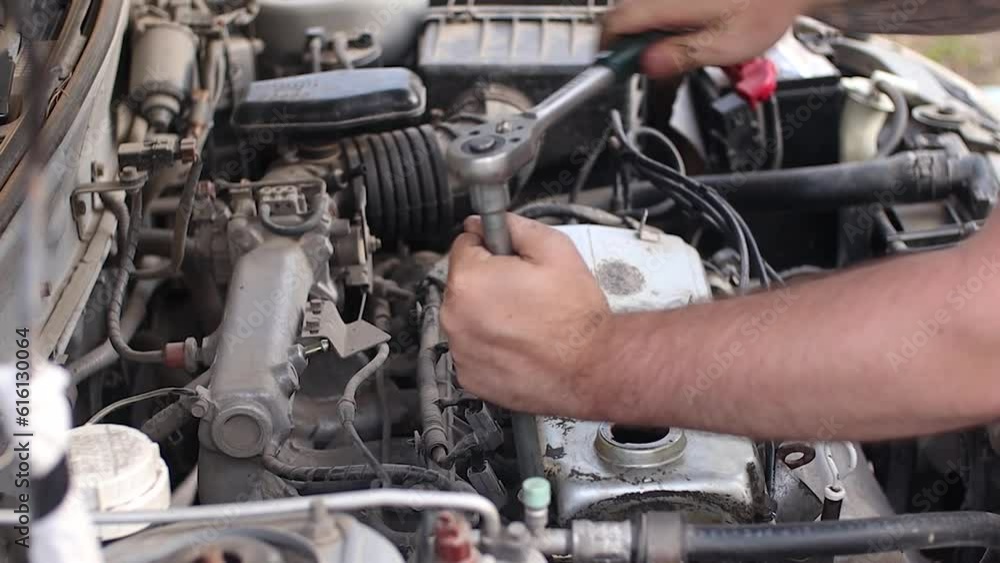 A man does a broach of the head. Makes car repair, engine malfunctioning. footage video A man does a broach of the head. Makes car repair, engine malfunctioning. footage video