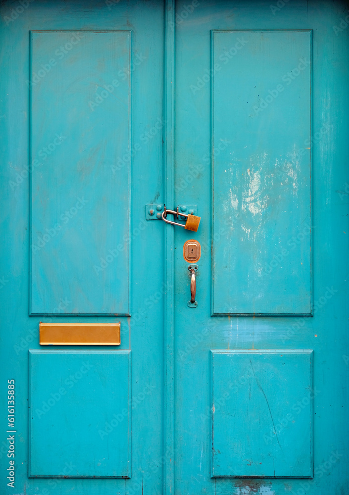 Turquoise wooden door with a padlock Turquoise wooden door with a padlock