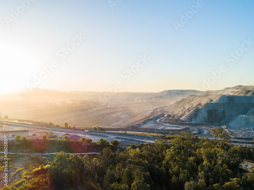 Environmental issue of bad air quality from open cut coal mine providing jobs for community photo