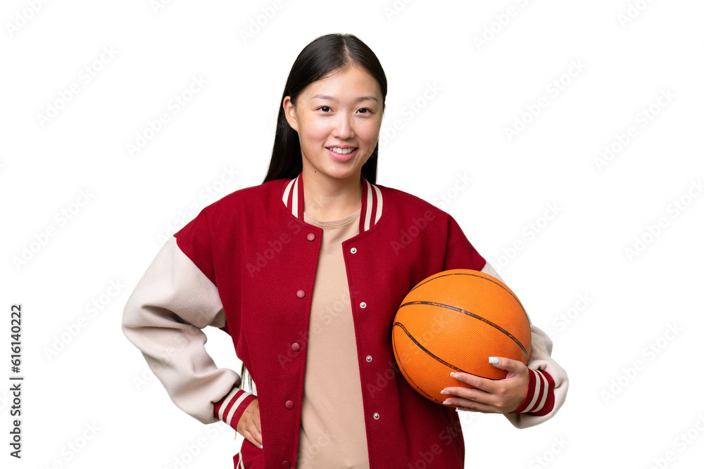 Young basketball player asian woman over isolated background posing with arms at hip and smiling