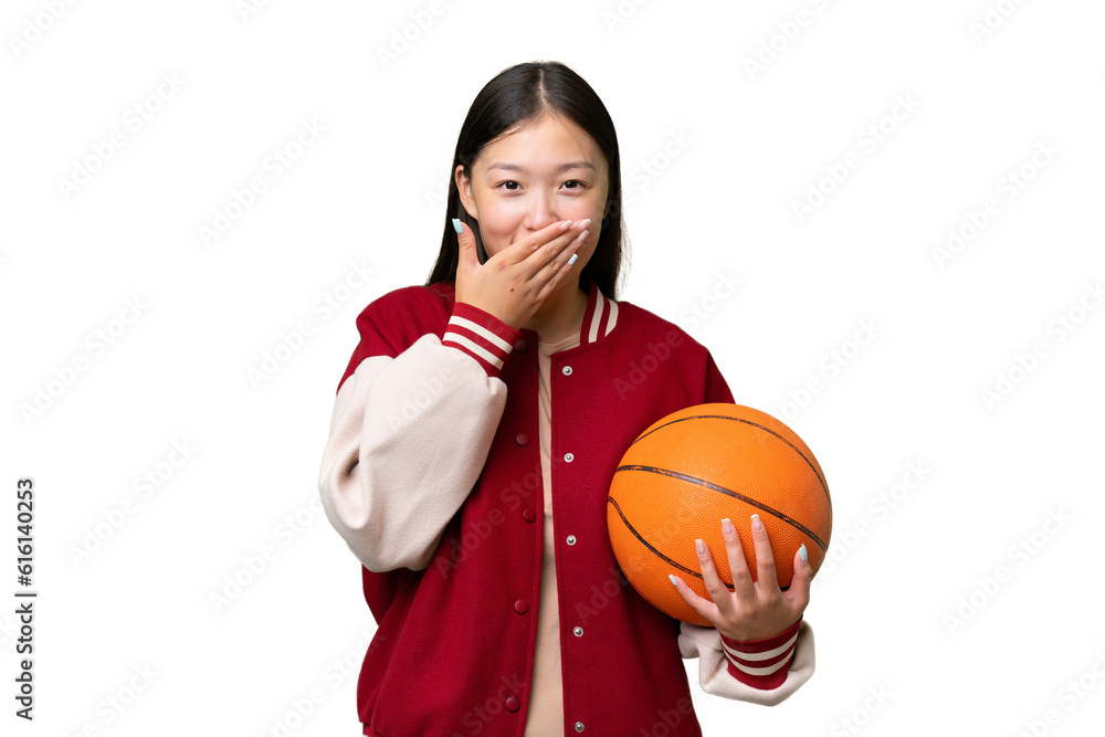 Young basketball player asian woman over isolated background happy and smiling covering mouth with hand