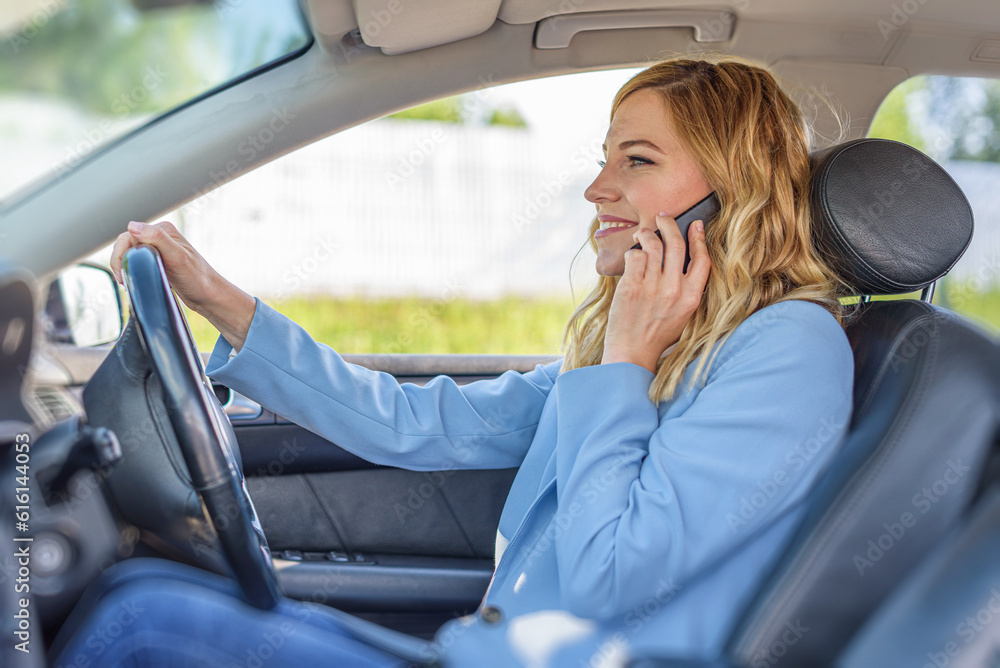 Young beautiful woman using smartphone while driving car Young beautiful woman using smartphone while driving car