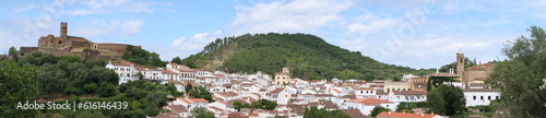 Almonaster la Real, Huelva, Spain, June 21, 2023: Panoramic of the mosque, bullring, town and church of Almonaster la Real in the Sierra de Aracena, Huelva, Spain © Marco Gallo
