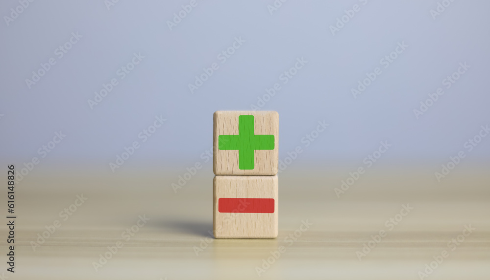 wooden blocks with plus and minus signs Comparatively opposite concepts ...