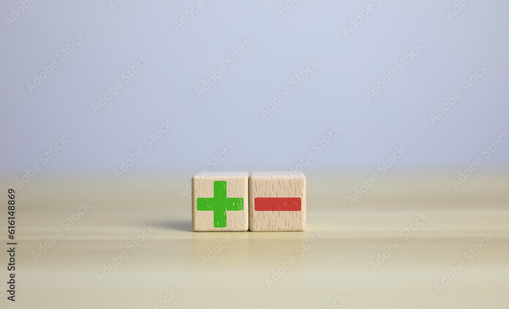 wooden blocks with plus and minus signs Comparatively opposite concepts ...