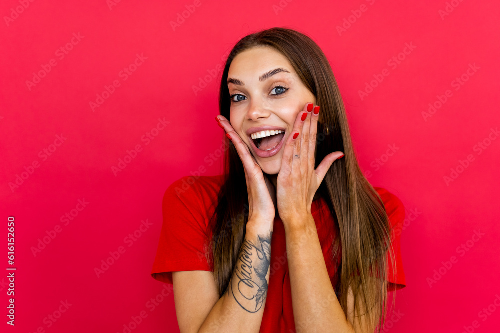 Screaming excited young woman standing isolated over red background. Screaming excited young woman standing isolated over red background.