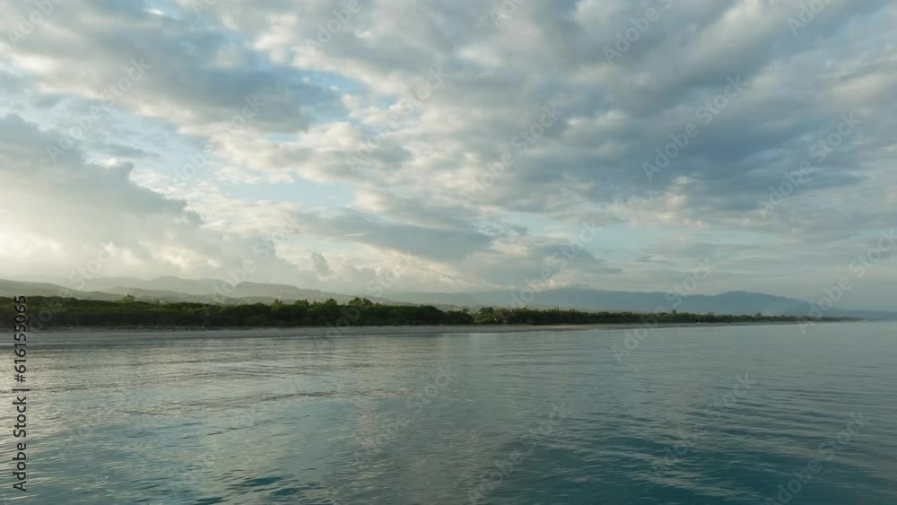 Calm ocean of tropical beach under cloudy sky. Calm ocean of tropical beach under cloudy sky.