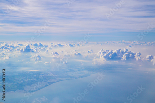 The Aerial view of Fluffy clouds Top view from airplane window, Nature background.
